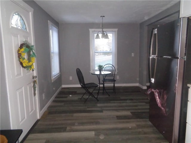 foyer with baseboards and dark wood-style flooring