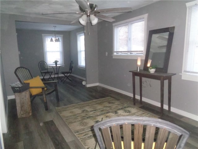 sitting room featuring baseboards, wood finished floors, and a ceiling fan