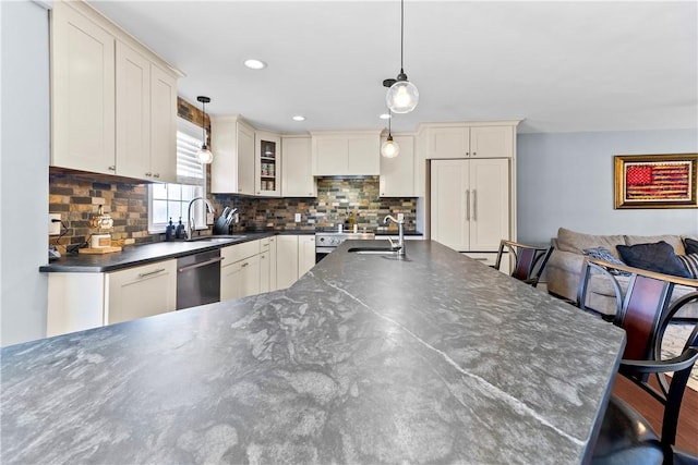 kitchen with pendant lighting, a sink, tasteful backsplash, and dishwasher