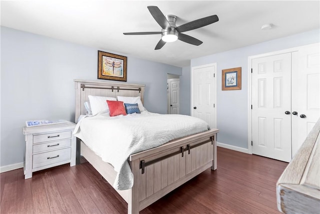 bedroom featuring baseboards, a ceiling fan, and dark wood-style flooring