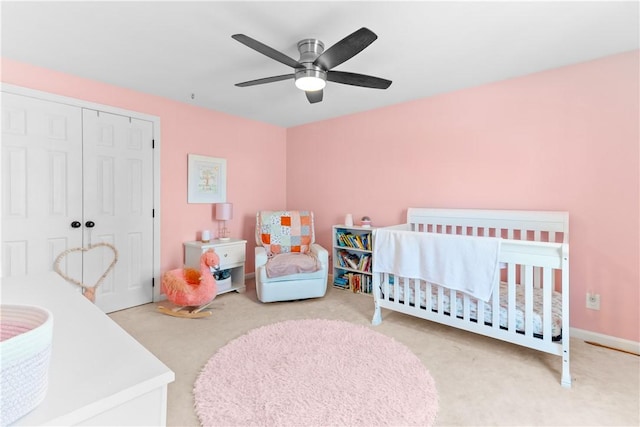 bedroom featuring a closet, ceiling fan, and a nursery area