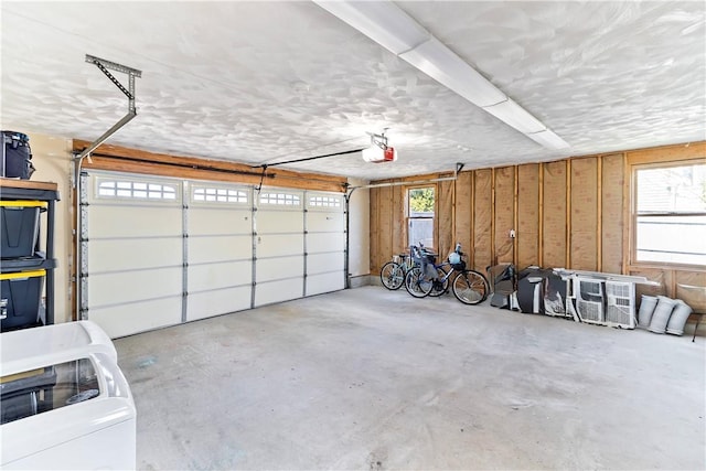 garage featuring washer / dryer and a garage door opener