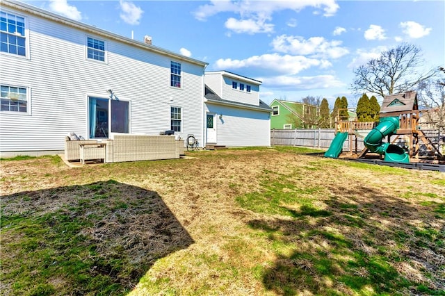view of yard with outdoor lounge area, fence, and a playground