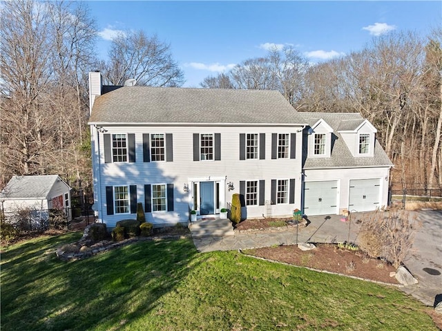 5 Nottingham Way, Freetown, MA 02702 - colonial inspired home with a chimney, concrete driveway, and an attached garage