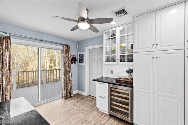 5 Nottingham Way, Freetown, MA 02702 - indoor dry bar with wine cooler, baseboards, ceiling fan, backsplash, and light wood-type flooring