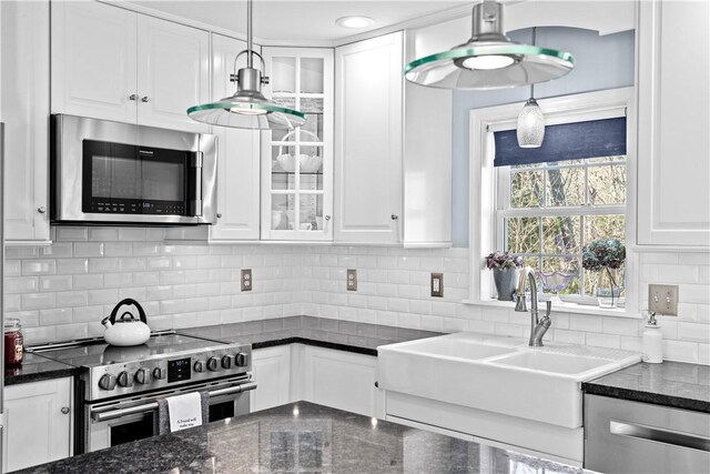5 Nottingham Way, Freetown, MA 02702 - kitchen featuring appliances with stainless steel finishes, white cabinetry, a sink, and glass insert cabinets