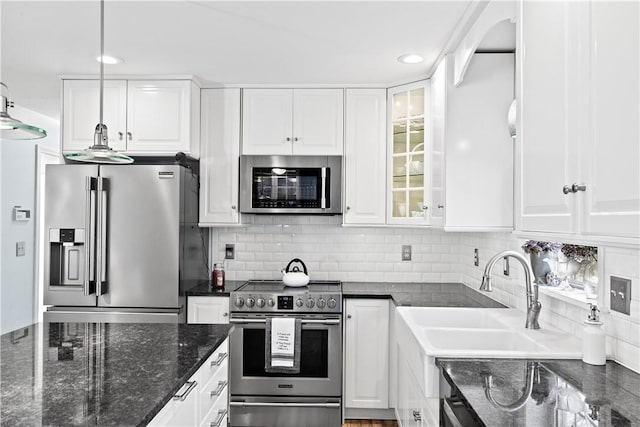 5 Nottingham Way, Freetown, MA 02702 - kitchen with stainless steel appliances, white cabinets, tasteful backsplash, glass insert cabinets, and recessed lighting