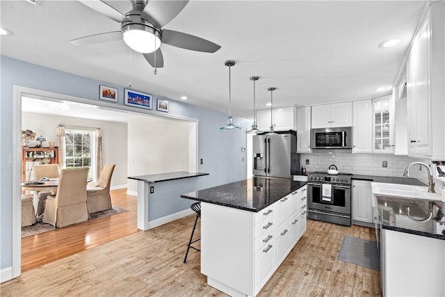 5 Nottingham Way, Freetown, MA 02702 - kitchen with appliances with stainless steel finishes, a sink, tasteful backsplash, ceiling fan, and light wood-style floors