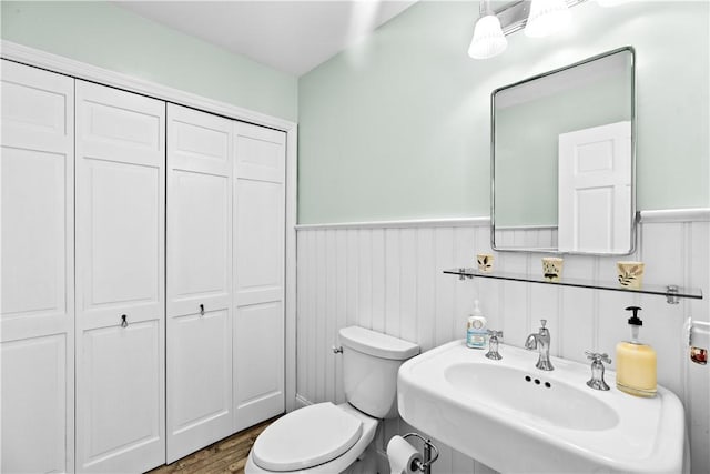 5 Nottingham Way, Freetown, MA 02702 - bathroom featuring a sink, wainscoting, toilet, a closet, and wood finished floors