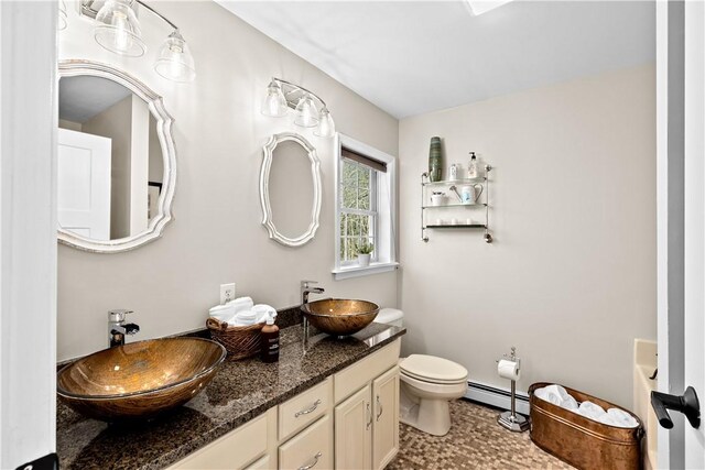 5 Nottingham Way, Freetown, MA 02702 - bathroom with a baseboard radiator, toilet, and double vanity