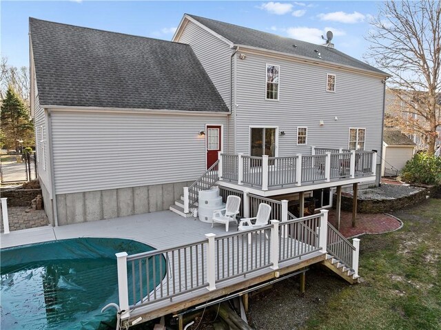 5 Nottingham Way, Freetown, MA 02702 - back of property with a wooden deck, stairs, roof with shingles, and a covered pool