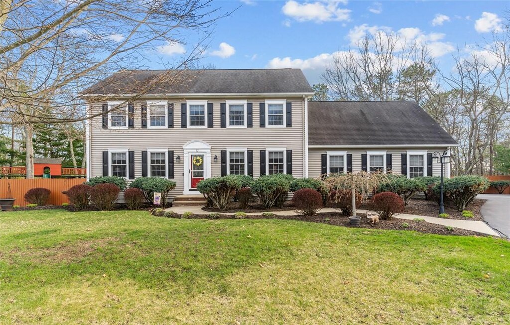 12 Kiley Way, Coventry, RI 02816 - colonial-style house with a front yard, fence, and roof with shingles