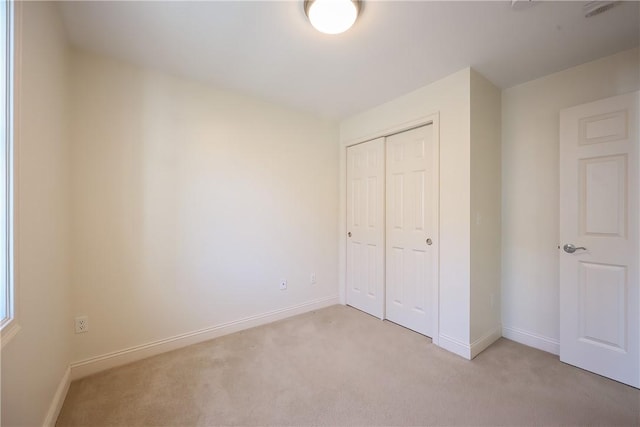 60 Bay Spring Ave Unit A5, Barrington, RI 02806 - unfurnished bedroom with light carpet, a closet, and baseboards