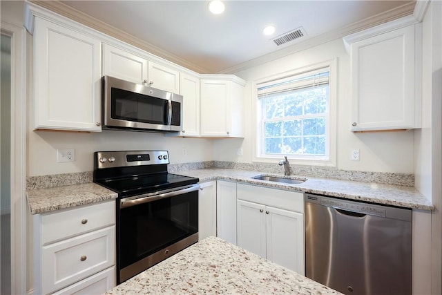 60 Bay Spring Ave Unit A5, Barrington, RI 02806 - kitchen featuring stainless steel appliances, white cabinets, a sink, light stone countertops, and crown molding