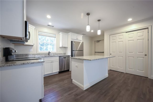 60 Bay Spring Ave Unit A5, Barrington, RI 02806 - kitchen featuring appliances with stainless steel finishes, ornamental molding, white cabinetry, a sink, and dark wood-style floors