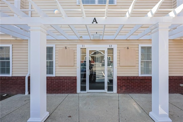 60 Bay Spring Ave Unit A5, Barrington, RI 02806 - entrance to property with brick siding, a pergola, and a patio