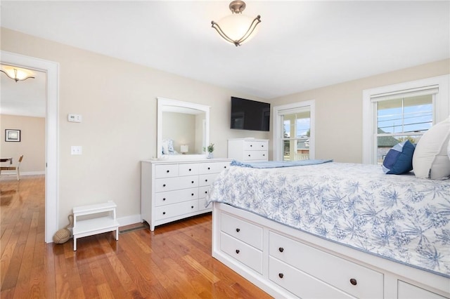 bedroom with baseboards and light wood-type flooring