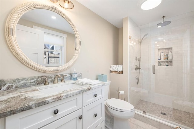 full bath with marble finish floor, toilet, a stall shower, and vanity