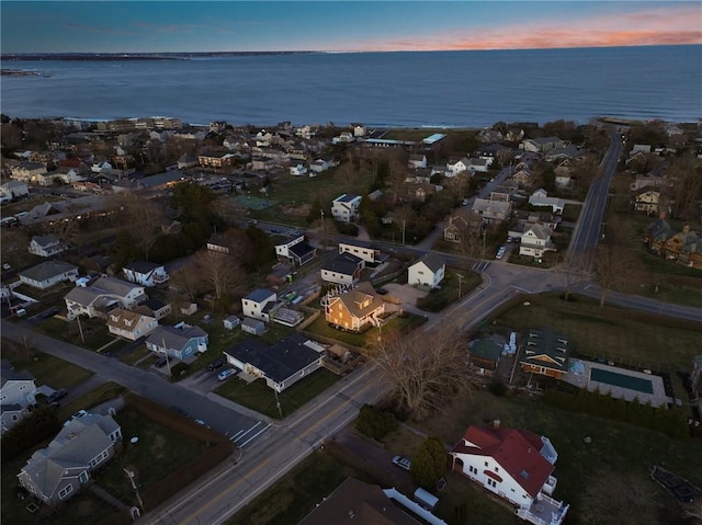 drone / aerial view featuring a residential view and a water view
