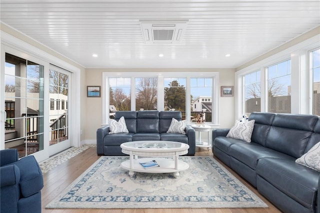 living room with baseboards and wood finished floors