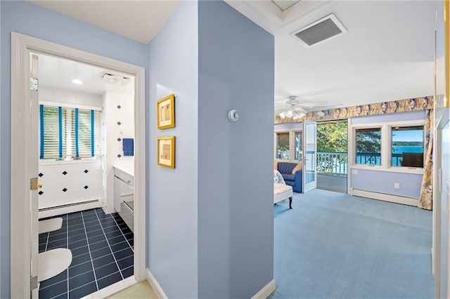 interior space with visible vents, baseboards, baseboard heating, carpet floors, and a baseboard heating unit