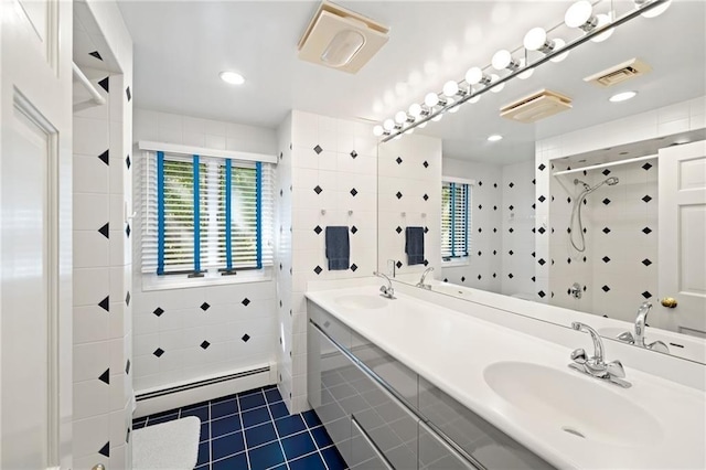bathroom with a sink, tile walls, baseboard heating, tile patterned flooring, and a stall shower