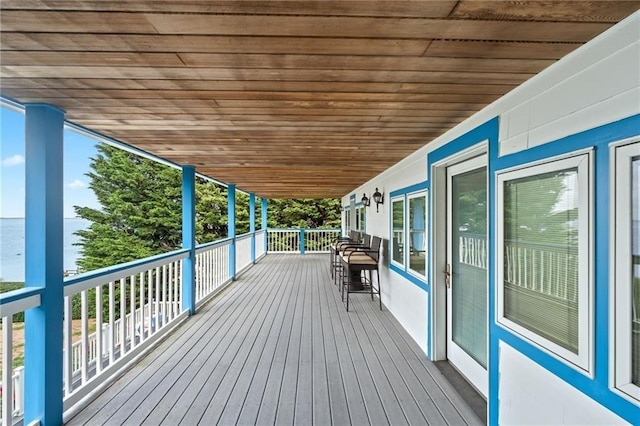 wooden deck featuring a water view