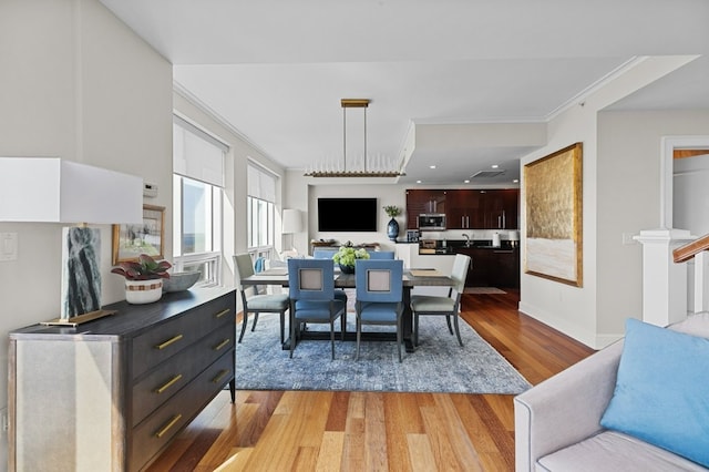 1 Tower Dr Unit 1203, Portsmouth, RI 02871 - dining room with baseboards, light wood-style floors, and crown molding