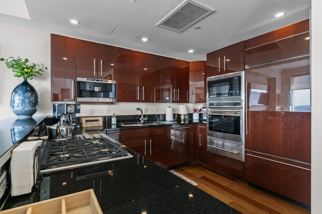 1 Tower Dr Unit 1203, Portsmouth, RI 02871 - kitchen with a warming drawer, a sink, visible vents, appliances with stainless steel finishes, and wood finished floors