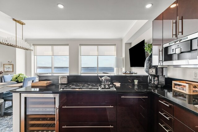 1 Tower Dr Unit 1203, Portsmouth, RI 02871 - kitchen featuring stainless steel gas cooktop, modern cabinets, ornamental molding, and beverage cooler