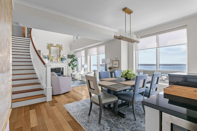 1 Tower Dr Unit 1203, Portsmouth, RI 02871 - dining area featuring a water view, ornamental molding, wood finished floors, and stairs