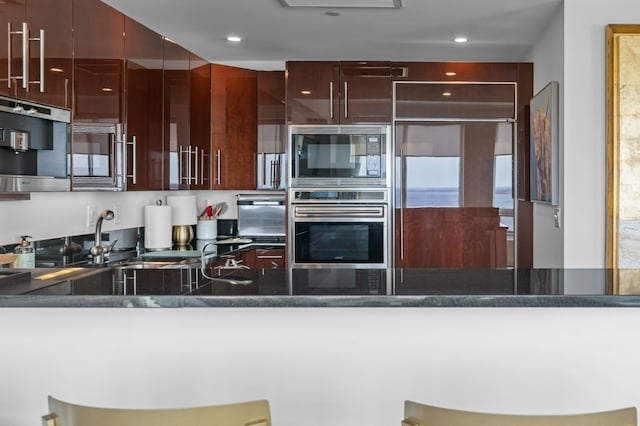 1 Tower Dr Unit 1203, Portsmouth, RI 02871 - kitchen featuring a sink, black microwave, a peninsula, and oven