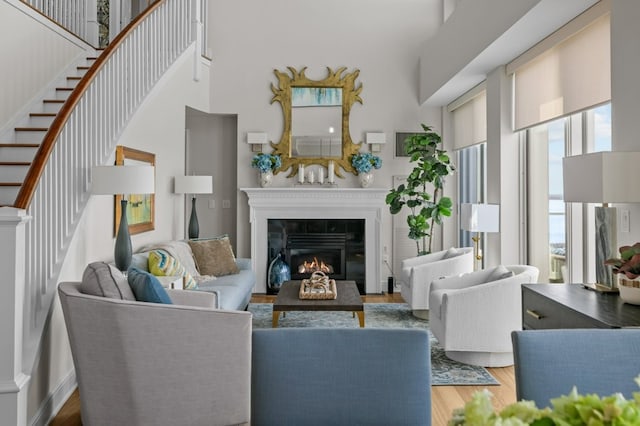 1 Tower Dr Unit 1203, Portsmouth, RI 02871 - living area featuring stairs, a high ceiling, wood finished floors, and a glass covered fireplace