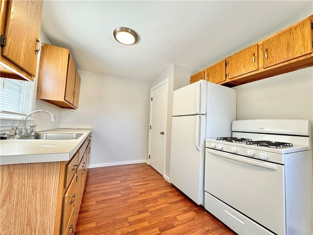 951 Main St, West Warwick, RI 02893 - kitchen featuring white appliances, light wood-style flooring, light countertops, and brown cabinets