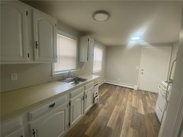 951 Main St, West Warwick, RI 02893 - kitchen featuring baseboard heating, white cabinets, light countertops, dark wood-type flooring, and white range