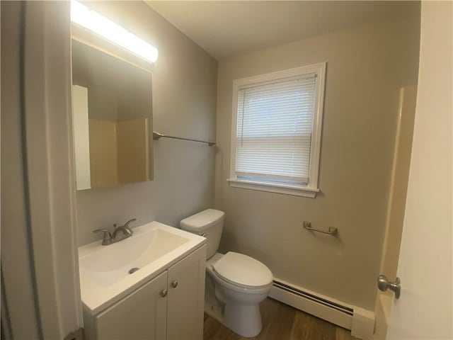 951 Main St, West Warwick, RI 02893 - full bathroom with a baseboard heating unit, vanity, and wood finished floors
