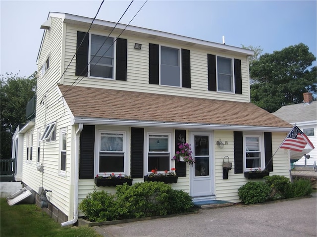 view of property featuring roof with shingles