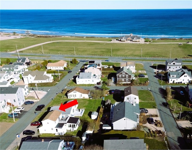 drone / aerial view featuring a water view and a residential view