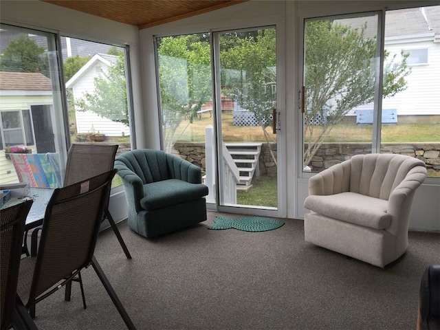 sunroom with wooden ceiling and carpet