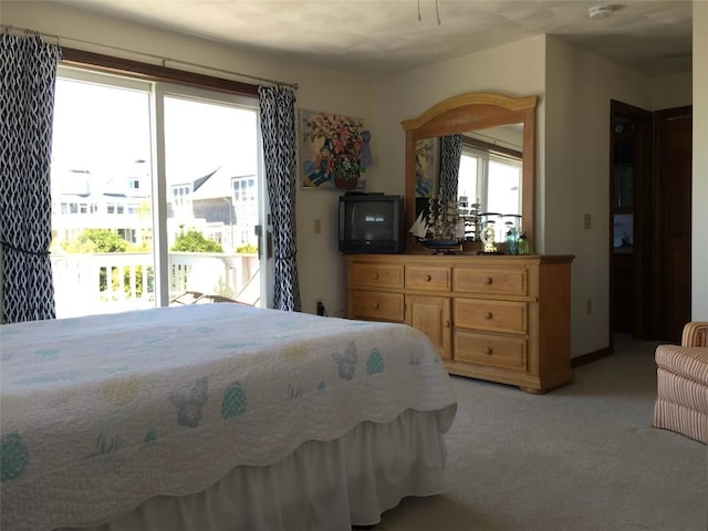 bedroom featuring light carpet and access to outside