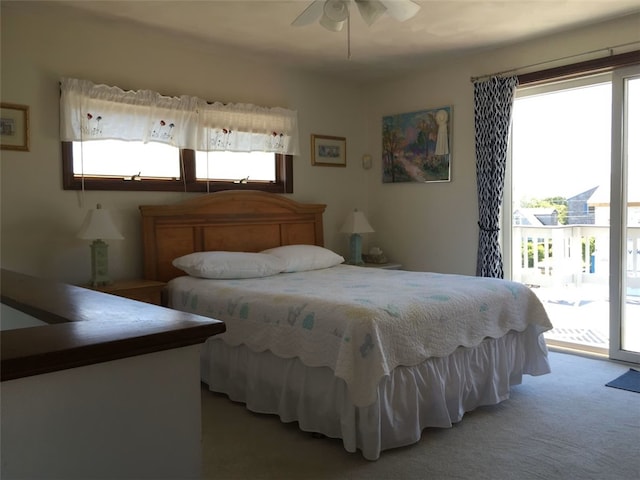 bedroom featuring light colored carpet, access to exterior, and ceiling fan