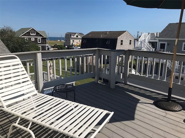 wooden terrace featuring a residential view