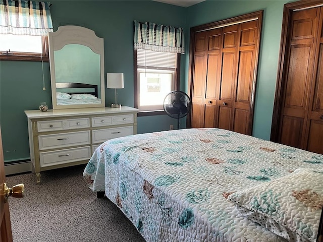 bedroom with a baseboard heating unit and multiple windows