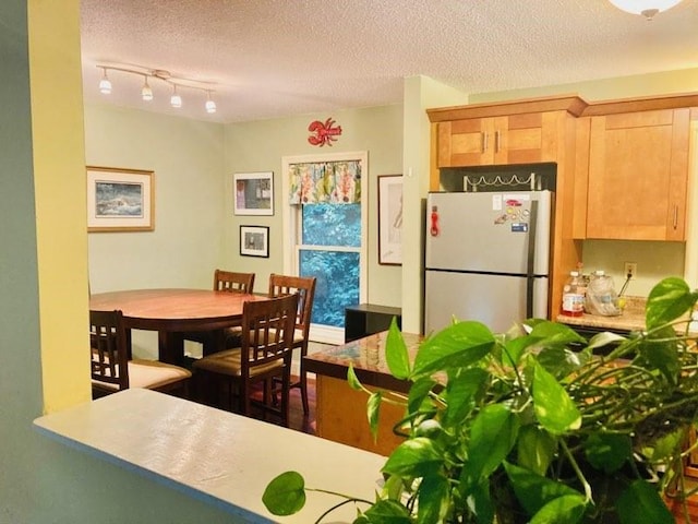 dining room featuring a textured ceiling