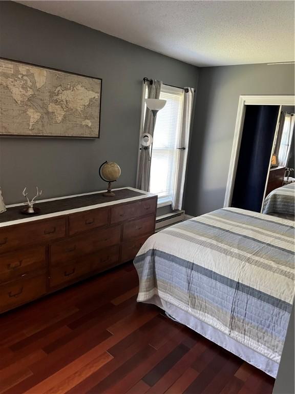 bedroom featuring dark wood finished floors