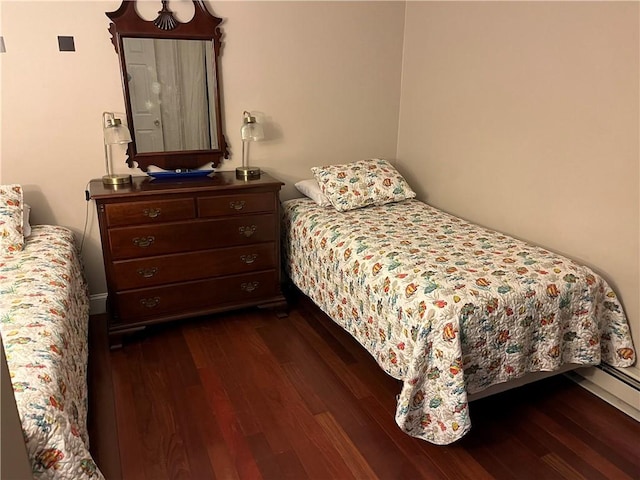 bedroom with dark wood finished floors