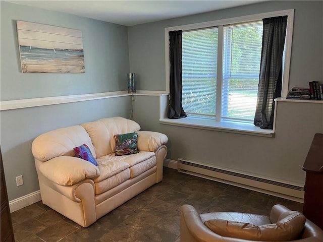 sitting room featuring baseboards, stone finish flooring, and baseboard heating