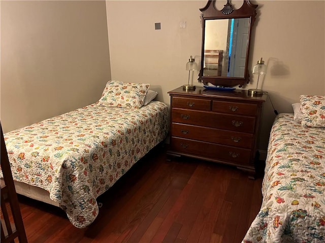 bedroom with dark wood-type flooring