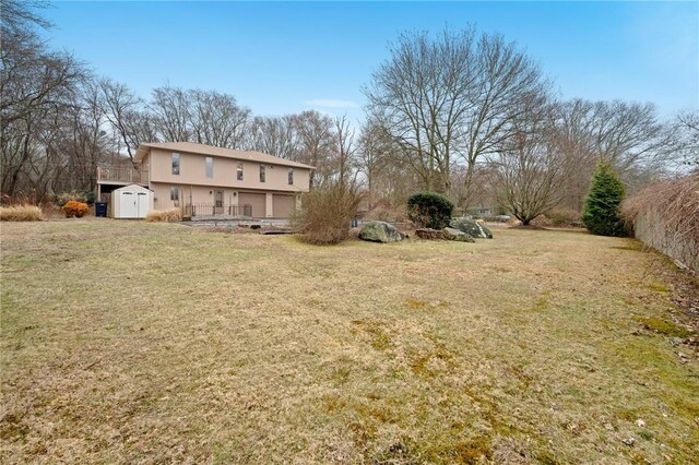 view of yard with a storage shed and an outbuilding