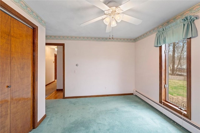 unfurnished bedroom featuring a baseboard radiator, carpet flooring, baseboards, and a ceiling fan